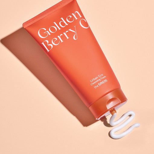ProtoClinical k-beauty The SAEM Urban Eco Golden Berry C Cleansing Foam 150ml single cleanser package in a close-up view with warm yellow accents on a white background.