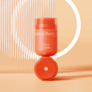 ProtoClinical k-beauty The SAEM Urban Eco Golden Berry C Eye Cream 30ml coral-orange eye cream jar standing upright on its matching round lid in front of a white ring light on a peach background