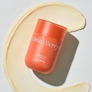 ProtoClinical k-beauty The SAEM Urban Eco Golden Berry C Eye Cream 30ml coral-orange eye cream jar angled over a pale cream swirl on a light gray background