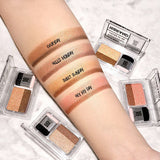 ProtoClinical k-beauty 16BRAND Sixteen Eye Magazine (7colors) arm swatch with four labeled shimmer and matte eyeshadow stripes beside four clear dual-shadow compacts on a marble background