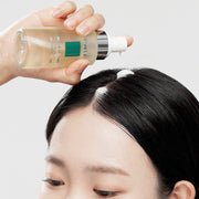 ProtoClinical k-beauty ViveLab Revive Therapy Hair Scalp Enhancing Foam 100ml clear pale yellow pump bottle held above a parted scalp with white foam on dark hair