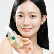 ProtoClinical k-beauty ViveLab Revive Therapy Hair Scalp Enhancing Foam 100ml model portrait holding a clear pale yellow bottle with a white pump cap against a light background