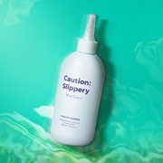 ProtoClinical k-beauty withbecon Caution Slippery Hair Treatment 300ml single upright pale gray treatment bottle centered on a turquoise background with a dark green right panel