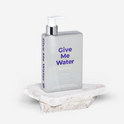 ProtoClinical k-beauty withbecon GiveMeWater Shampoo 360ml tall gray shampoo bottle silhouette on a soft white background with pale lavender side accents