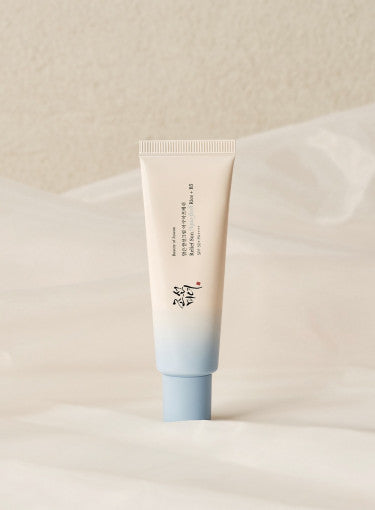 ProtoClinical k-beauty [Beauty of Joseon] Relief Sun Aqua-fresh Rice+B5 (SPF50+ PA++++) 50ml single upright pale blue sunscreen tube centered on a white background with soft peach side accents.