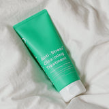 ProtoClinical k-beauty One-day's you Anti-Stress Cica:ming Treatment 200ml bright green treatment package angled diagonally on a pale pink and mint background.