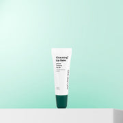 ProtoClinical k-beauty One-day's you Cica:ming Lip Balm 10ml single white lip balm tube with a deep green cap standing upright on a mint gradient background and white pedestal