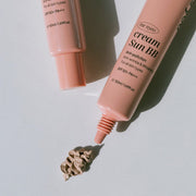 ProtoClinical k-beauty brown beauty bottle on a pale blue and white background.