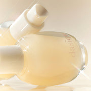 ProtoClinical k-beauty golden beauty product silhouette on a warm beige background.