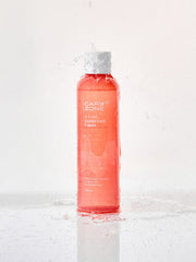 ProtoClinical k-beauty CAREZONE A-Cure Clarifying Toner 240ml single upright coral toner bottle centered on a pale blue background
