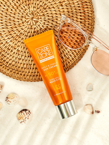 ProtoClinical k-beauty CAREZONE Daily & Family Sun Cream 80ml (SPF50+/PA+++) single upright orange package centered on a white background with pale blue corner accents