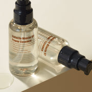 ProtoClinical k-beauty warm beige beauty detail with two pale vertical forms and a darker lower-right shape on a light background.