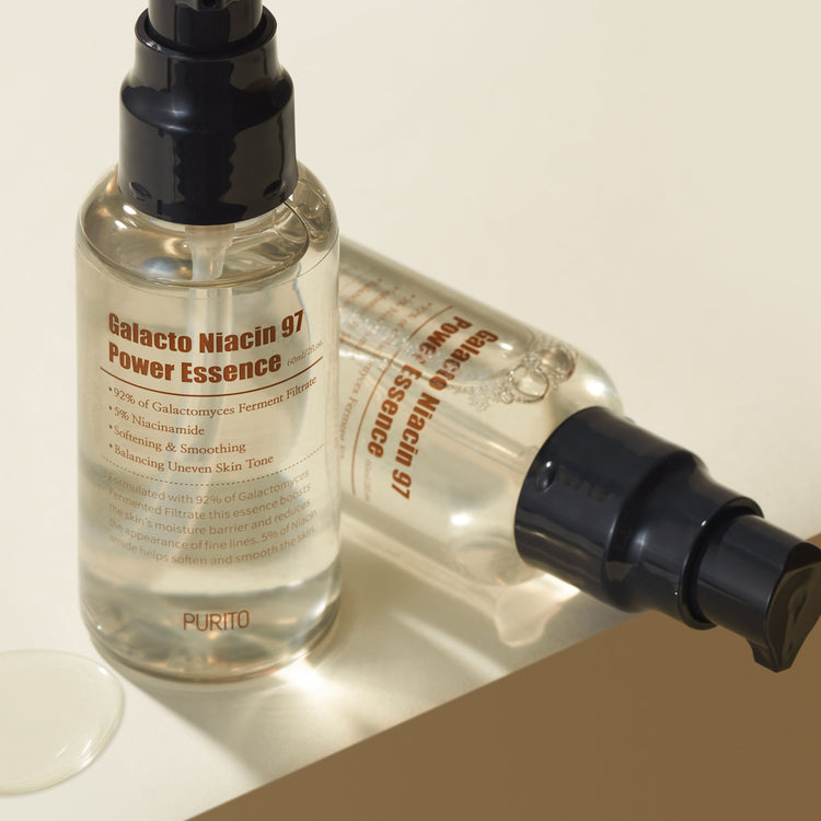 ProtoClinical k-beauty warm beige beauty detail with two pale vertical forms and a darker lower-right shape on a light background.