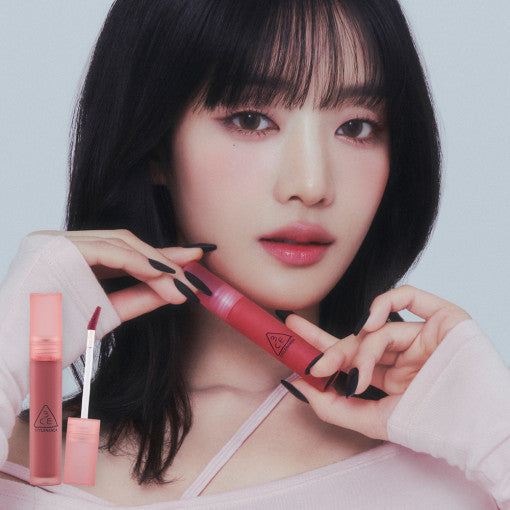 ProtoClinical k-beauty 3CE Blur Water Tint 4.6g single upright rose lip tint tube centered on a pale background with soft blue side bands