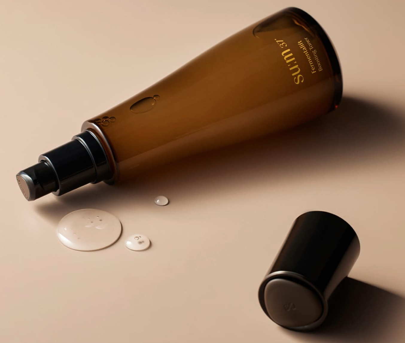 ProtoClinical k-beauty warm brown beauty detail image on a soft peach background.