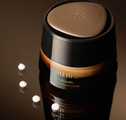 ProtoClinical k-beauty dark beauty product silhouette on a warm brown background.