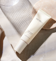 ProtoClinical k-beauty beauty product detail image with soft cream, lavender, and charcoal tones.