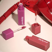 ProtoClinical k-beauty lilybyred Mood Liar Velvet Tint 4.2g single rosy lip tint swatch with a darker berry upper edge on a pale pink and beige background