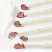 ProtoClinical k-beauty lilybyred Smiley Lip Blending Stick 0.8g single taupe rectangular package centered upright on a pale cream background with soft green side shading