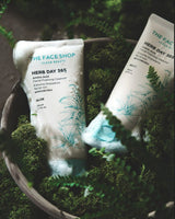ProtoClinical k-beauty THE FACE SHOP Herb Day 365 Amino Acid Facial Foaming Cleanser 170ml #Aloe shown as two white squeeze tubes with mint caps nestled in moss and soap foam inside a rustic bowl