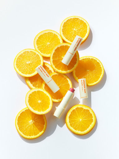 ProtoClinical k-beauty THE FACE SHOP Vitamin Sun Lip Balm SPF 22 PA+++ 3.9g single bright yellow lip balm package centered above a pale blue lower band on a light background