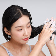 ProtoClinical k-beauty warm beige beauty detail with a dark vertical form on a light background.