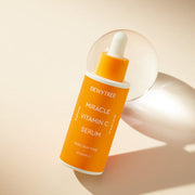 ProtoClinical k-beauty DEWYTREE Miracle Vitamin C Serum 40ml single upright orange serum bottle centered on a pale background with soft blue side panels