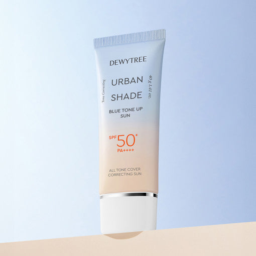 ProtoClinical k-beauty DEWYTREE Urban Shade Blue Tone Up Sun 40g single upright sunscreen tube centered on a soft blue and beige background.
