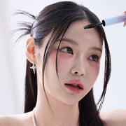ProtoClinical k-beauty warm brown beauty product close-up with a dark top and pale blue side accents on a light background.