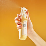 ProtoClinical k-beauty Daleaf Origin No-Wash Treatment 150ml single upright beige treatment bottle centered on a warm yellow background