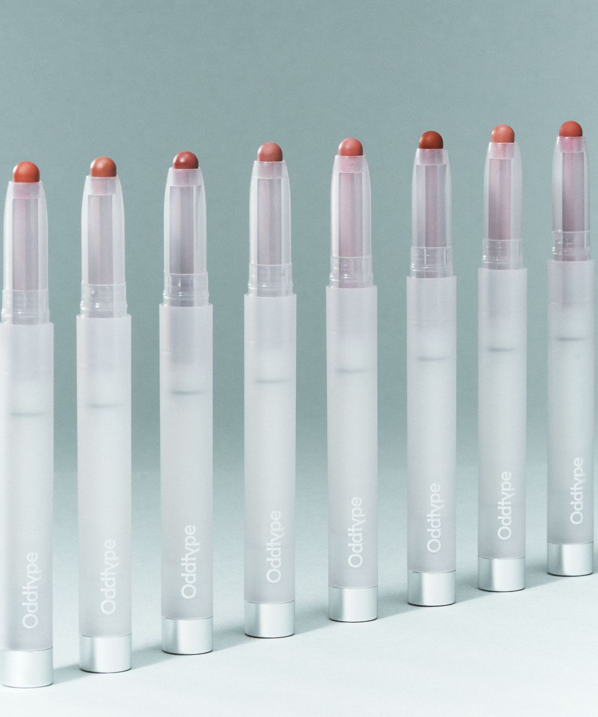 ProtoClinical k-beauty Oddtype New Rules Blur Balm single upright dark gray blur balm package centered on a pale blue-gray background