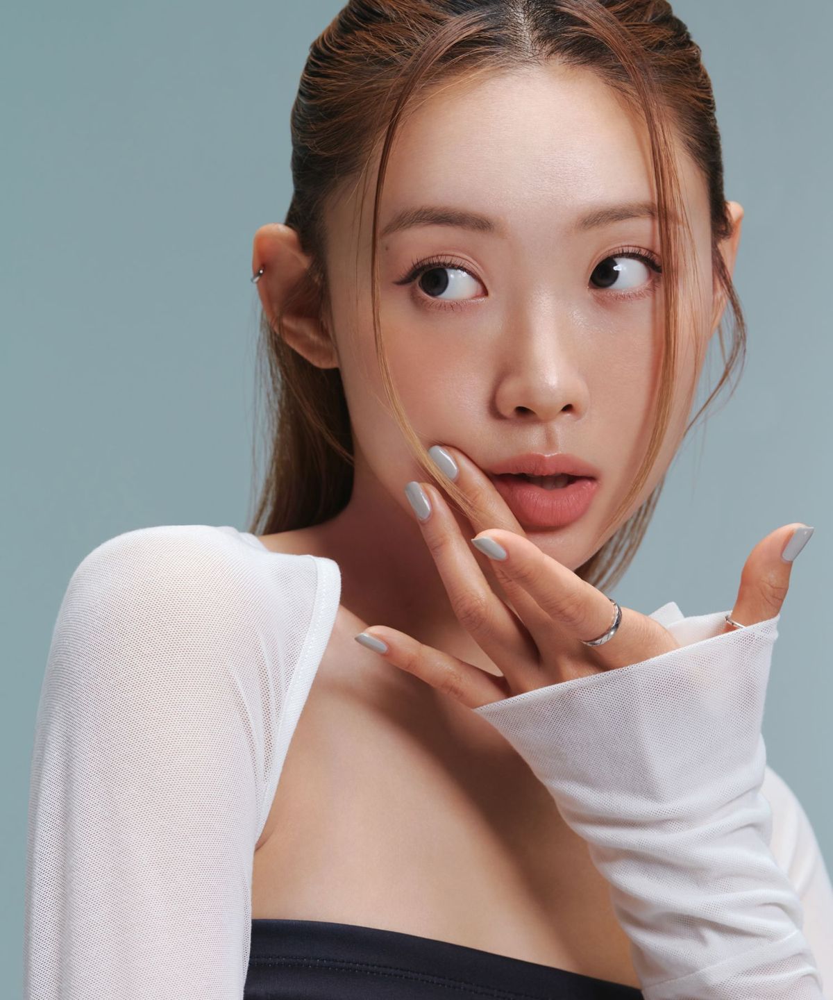 ProtoClinical k-beauty Oddtype New Rules Blur Balm single vertical peach-brown lip balm swatch with pale aqua side shading on a light background
