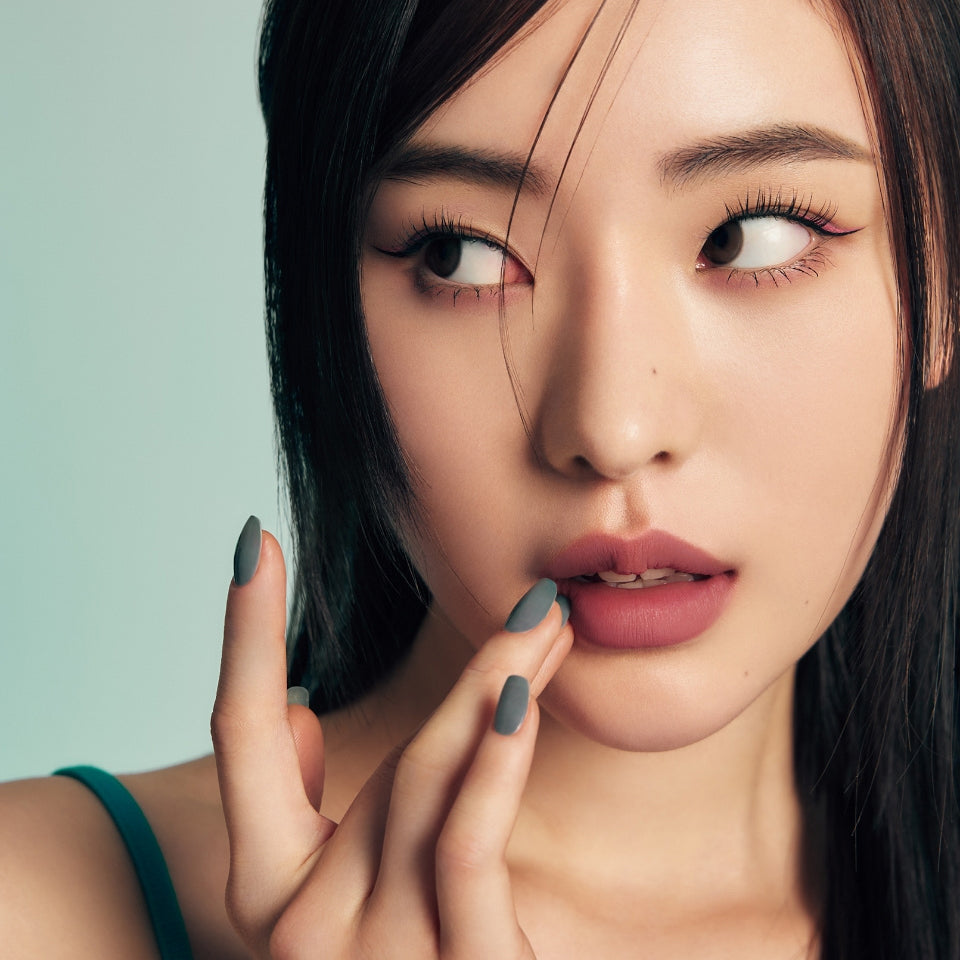 ProtoClinical k-beauty Oddtype New Rules Lip Liner single vertical beige lip liner swatch with aqua side shading on a warm brown background