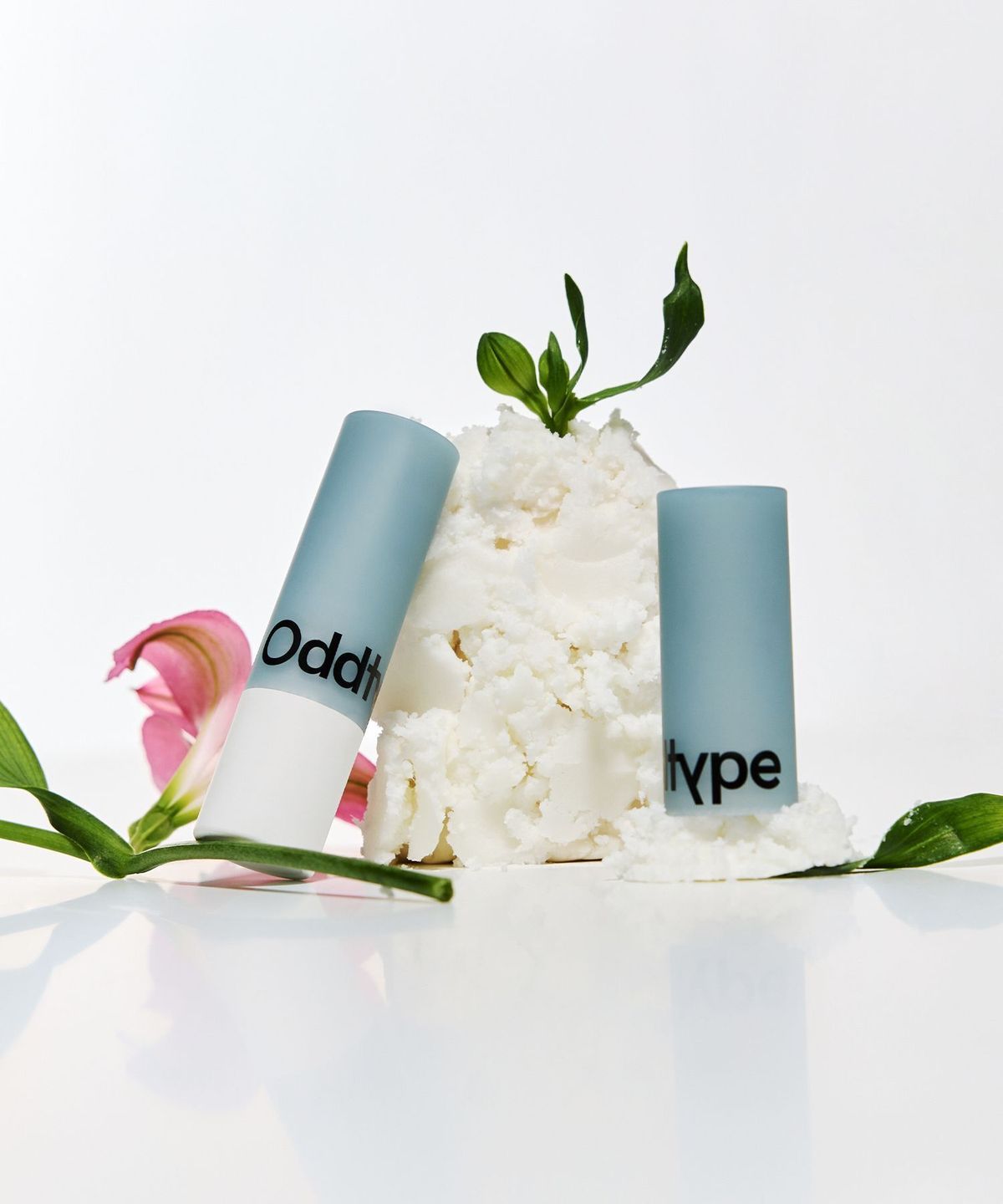ProtoClinical k-beauty Oddtype Over the Natural Lip Balm single lip balm detail shown in a vertical close-up on a light background
