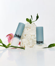 ProtoClinical k-beauty Oddtype Over the Natural Lip Balm single lip balm detail shown in a vertical close-up on a light background