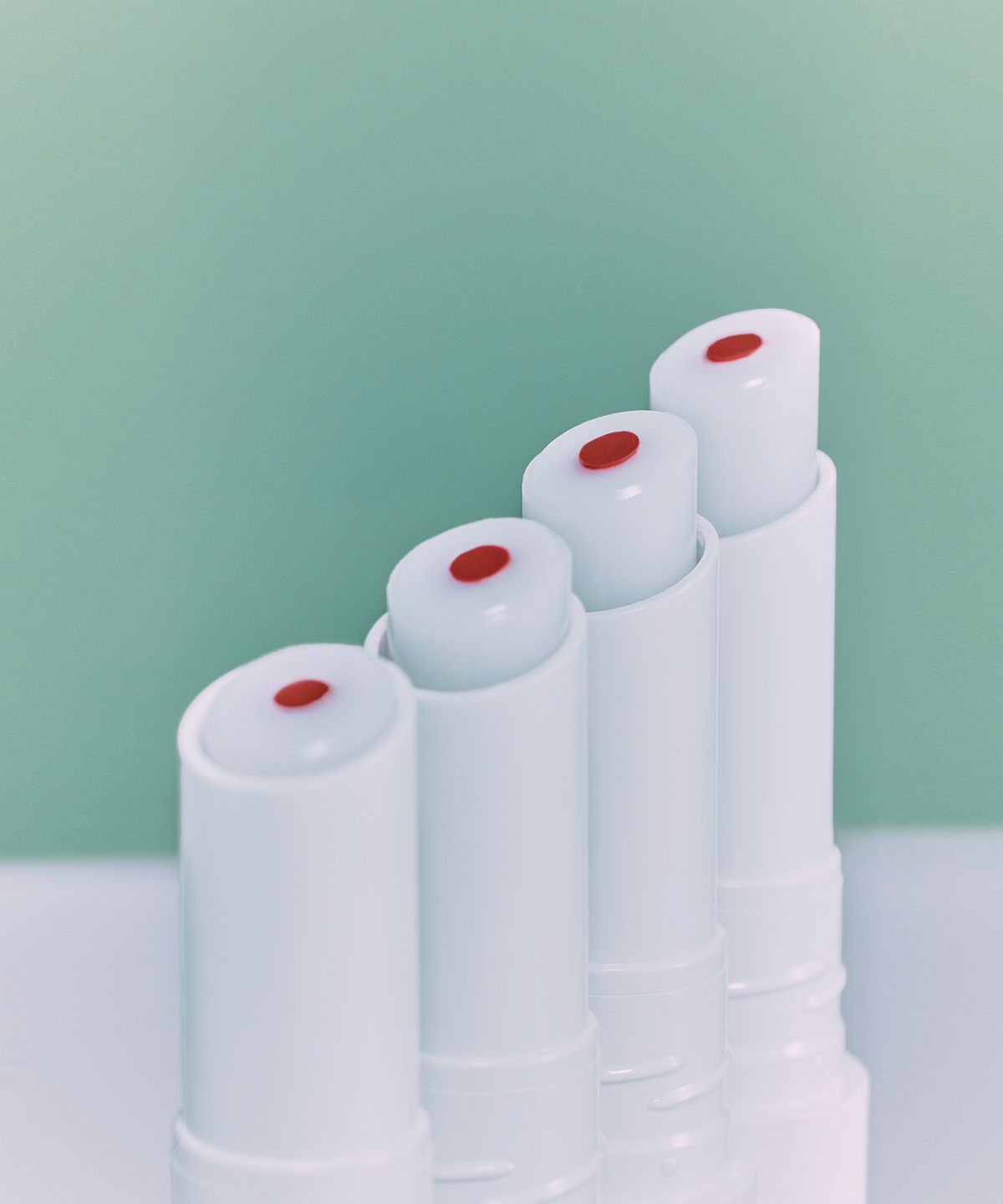 ProtoClinical k-beauty Oddtype Over the Natural Lip Balm cool teal and gray lip balm detail with a pale lavender lower fade in a vertical close-up