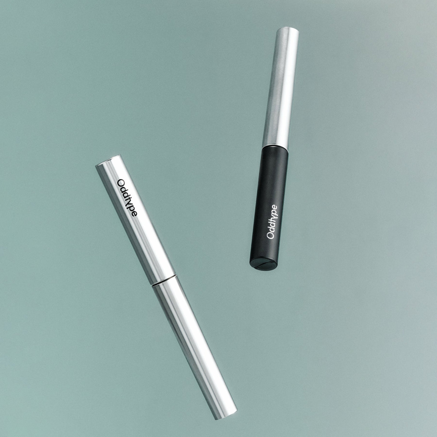 ProtoClinical k-beauty Oddtype Unlimited Curl Lift Mascara single upright mascara tube centered on a white background with soft lavender side shading