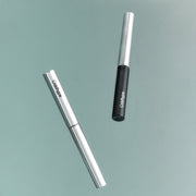 ProtoClinical k-beauty Oddtype Unlimited Curl Lift Mascara single upright mascara tube centered on a white background with soft lavender side shading