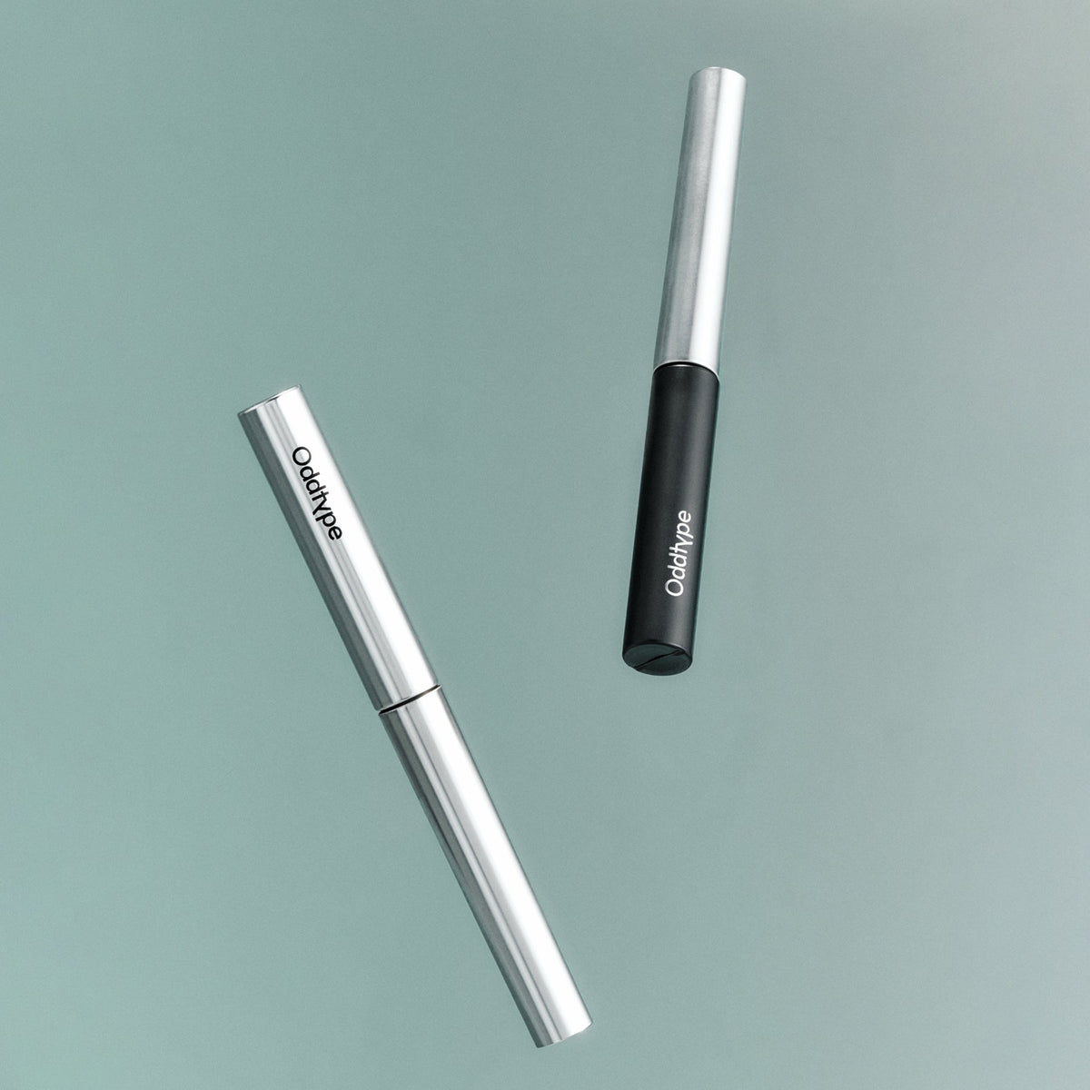 ProtoClinical k-beauty Oddtype Unlimited Curl Lift Mascara single upright mascara tube centered on a white background with soft lavender side shading