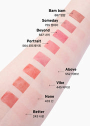 ProtoClinical k-beauty Oddtype Unscene Dew Glow Balm single vertical rosy lip balm swatch centered on a pale background with soft aqua corner shading