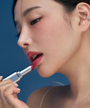 ProtoClinical k-beauty Oddtype Unscene Dew Glow Balm warm beige rounded lip balm detail framed by teal side panels on a light background
