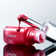 ProtoClinical k-beauty Oddtype Unseen Balloon Tint single upright lip tint tube centered on a pale aqua and blush pink background