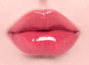 ProtoClinical k-beauty Oddtype Unseen Balloon Tint bright pink lip tint swatch centered on a pale pink background with soft green corner accents