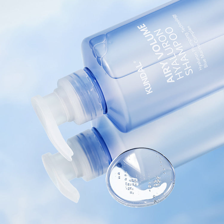 ProtoClinical k-beauty KUNDAL AIRY VOLUME HYALURON SHAMPOO 500ml #BLOSSOM BREEZE single upright blue shampoo bottle centered on a white background with pale blue side panels.