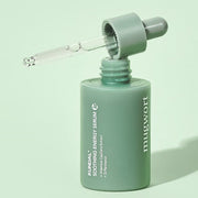 ProtoClinical k-beauty KUNDAL Mugwort Soothing Energy Serum 30ml single deep green serum bottle centered on a pale green background with soft horizontal bands