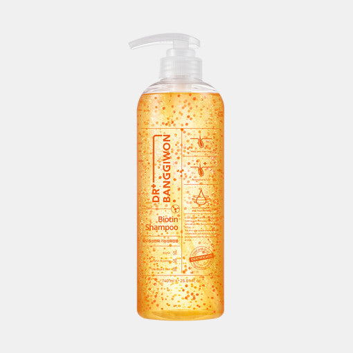 ProtoClinical k-beauty Dr.BANGGIWON Biotin Shampoo 740ml single pale yellow shampoo bottle centered on a pale blue background.