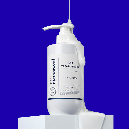 ProtoClinical k-beauty Dr.BANGGIWON LAB TREATMENT RX 480ml white pump bottle with cream spill on a vivid blue background and white pedestal