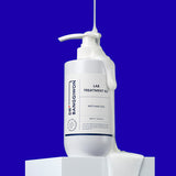 ProtoClinical k-beauty Dr.BANGGIWON LAB TREATMENT RX 480ml white pump bottle with cream spill on a vivid blue background and white pedestal