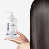 ProtoClinical k-beauty Dr.BANGGIWON LAB TREATMENT RX 480ml white pump bottle with cream spill on a vivid blue background and white pedestal