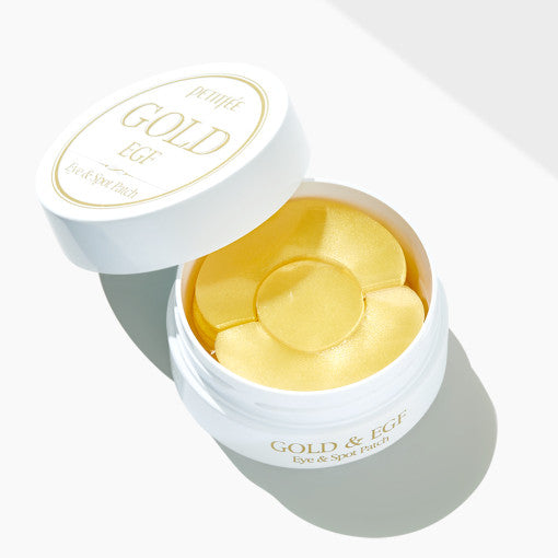 ProtoClinical k-beauty PETITFEE GOLD EGF EYE & SPOT PATCH (EYE patch 1.1g X 60 Patches + SPOT patch 0.6g X 30 Patches) single warm yellow eye patch package laid horizontally on a pale blue and cream background